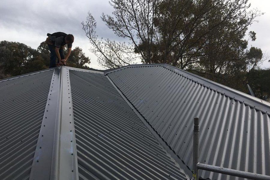 guy fixing roof