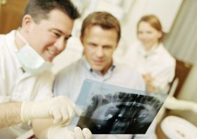 Emergency dentist checking an x-ray in Bankstown
