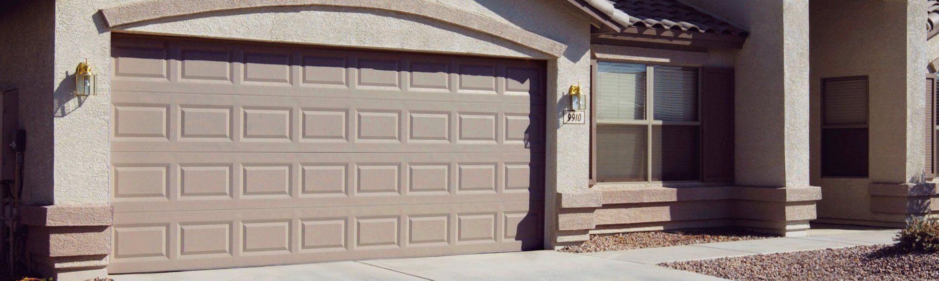 Two-car tan garage door. Two-car tan garage door.