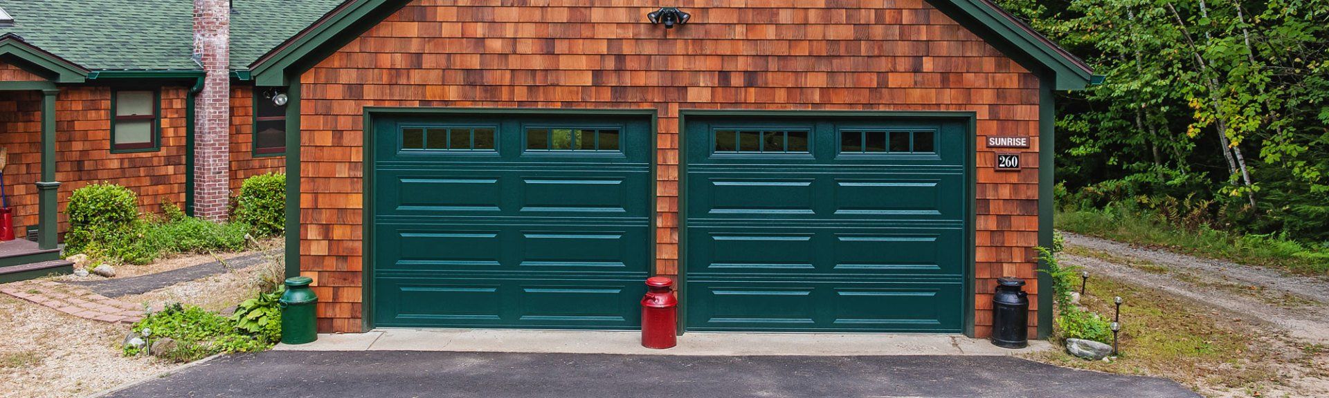 Green garage doors on wood house Green garage doors on wood house