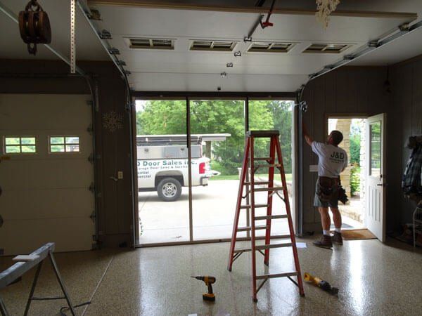 Man Installing Screen Door — Big Rock, IL | J&D Door Sales Inc.