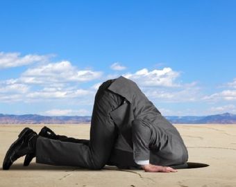 man with head in sand