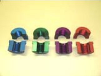 A group of colorful aluminum clips are sitting on top of each other on a table.