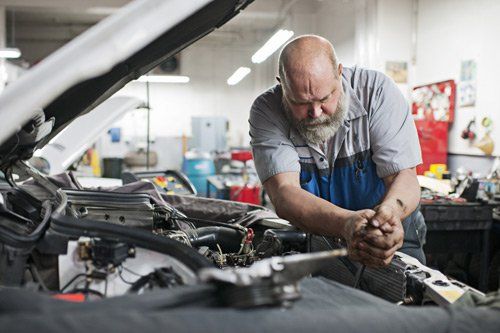mechanic working on radiator
