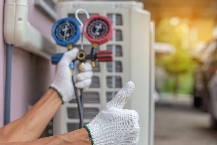 Residential Furnaces — Repairman Fixing Air Conditioning System in Champaign, IL
