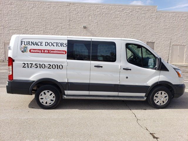 Residential Furnaces — Repairman Fixing Air Conditioning System in Champaign, IL Residential Furnaces — Repairman Fixing Air Conditioning System in Champaign, IL