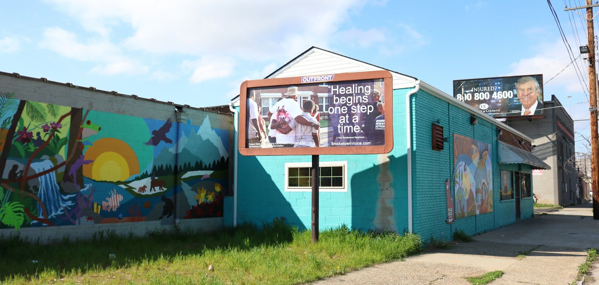 A blue building with a billboard on the side of it.