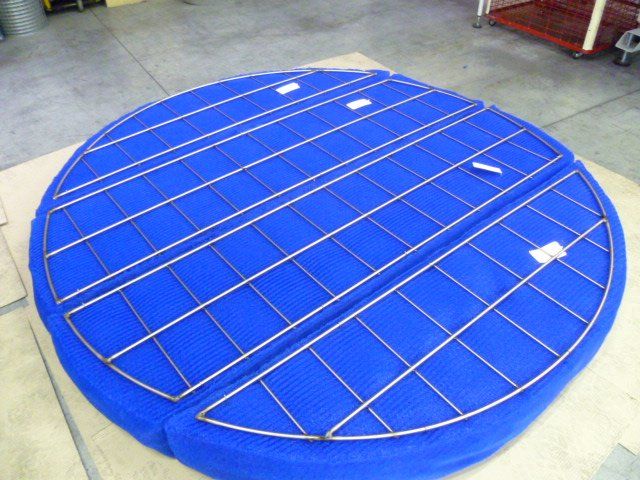 Woven metal mesh filters with synthetic overlay