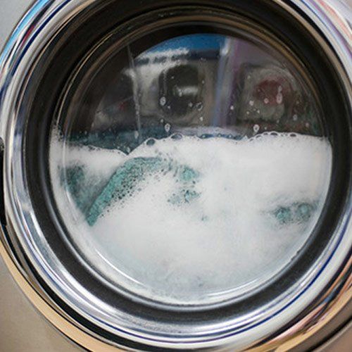 Home Appliances — Clothes Being Washed Inside a Washer in Bountiful, UT Home Appliances — Clothes Being Washed Inside a Washer in Bountiful, UT
