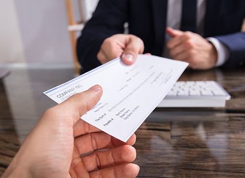 Check Being Handed to the Client — Cheyenne, WY — Lincolnway Super Pawn Check Being Handed to the Client — Cheyenne, WY — Lincolnway Super Pawn