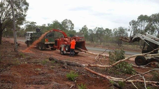 person using a red tree shredder