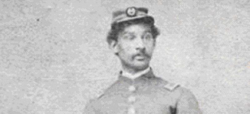 A black and white photo of a man in a military uniform.