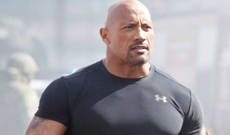 The rock is wearing a black under armour shirt.