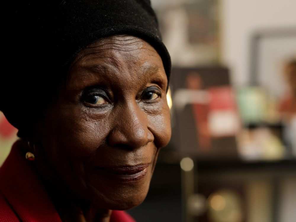 A close up of a woman wearing a black hat