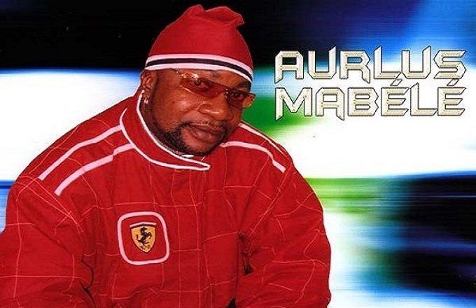 A man wearing a red jacket with the name aurlus mabele on it