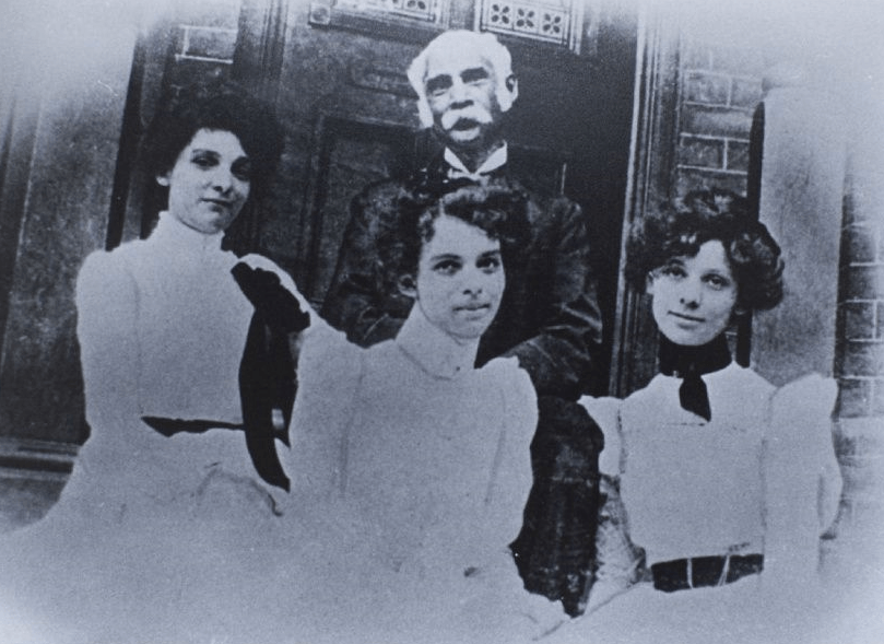 A black and white photo of a man and three women