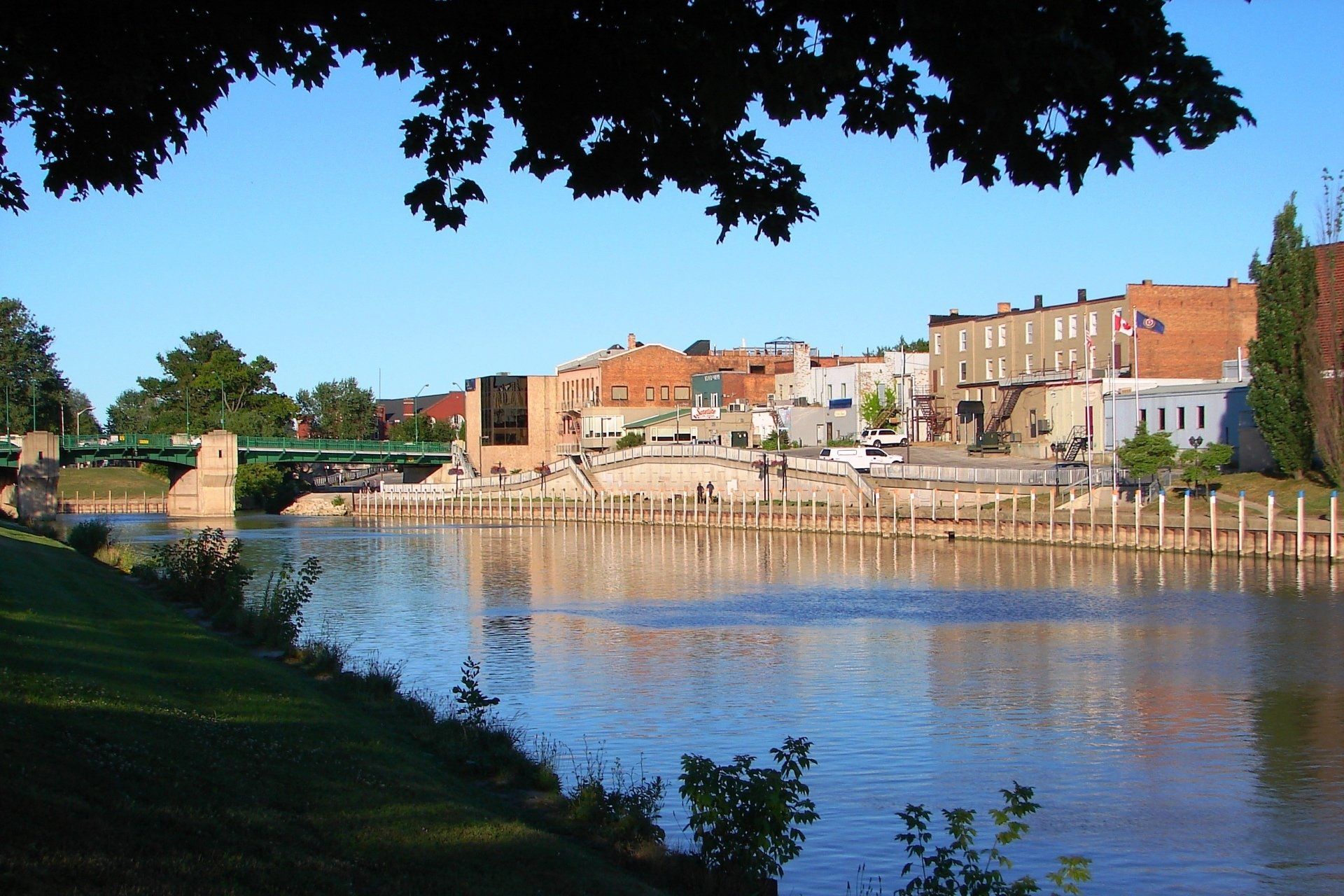 A bridge over a river with buildings in the background