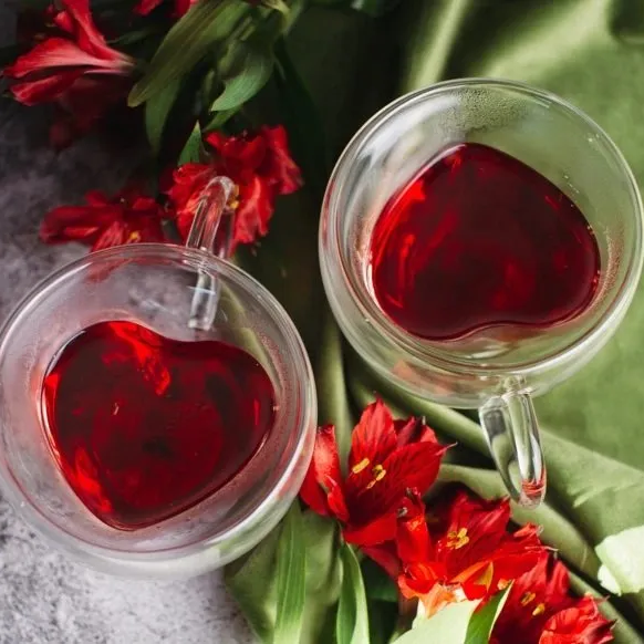 Two cups of red liquid in the shape of a heart
