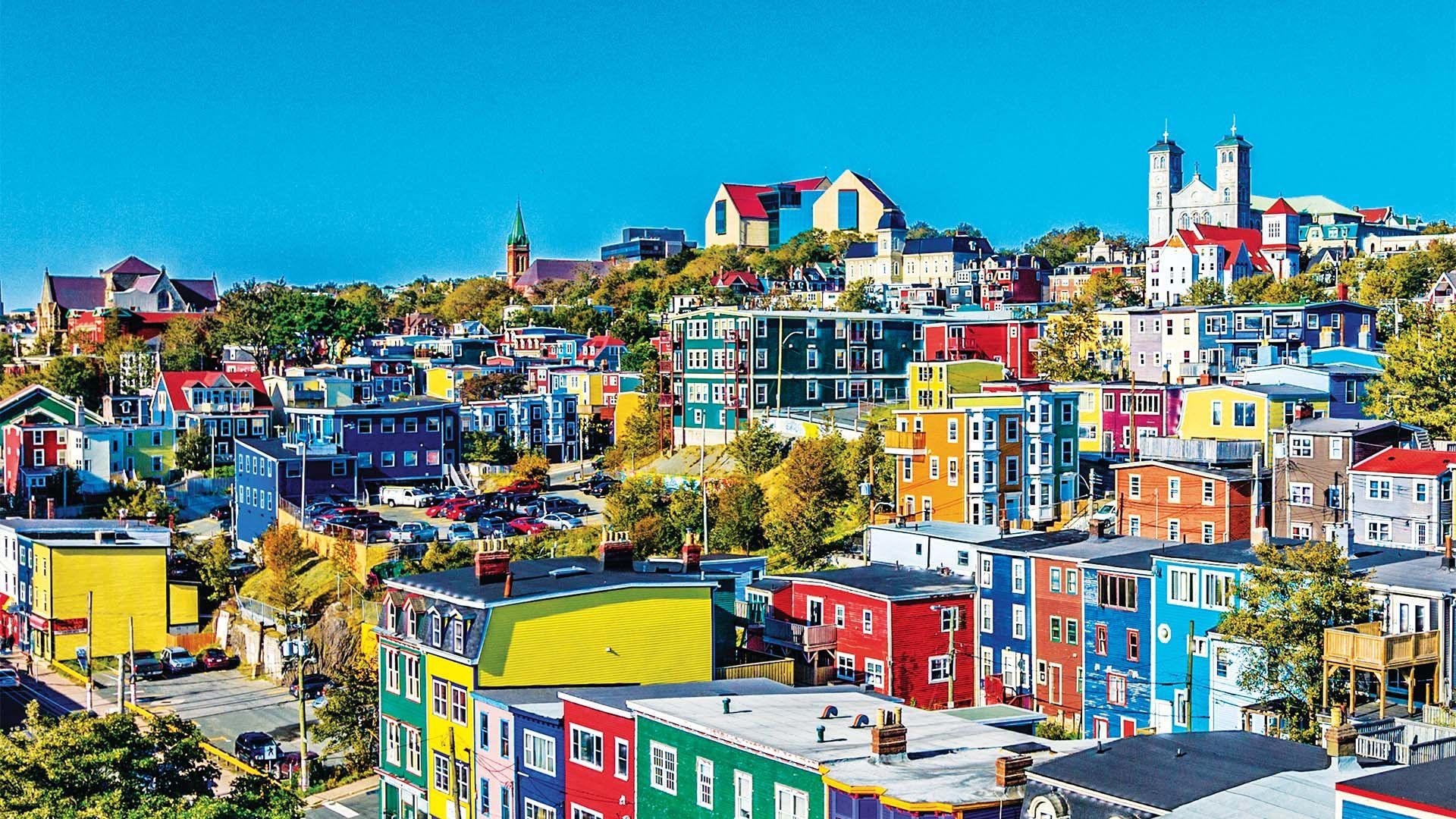 An aerial view of a colorful city with a blue sky in the background.