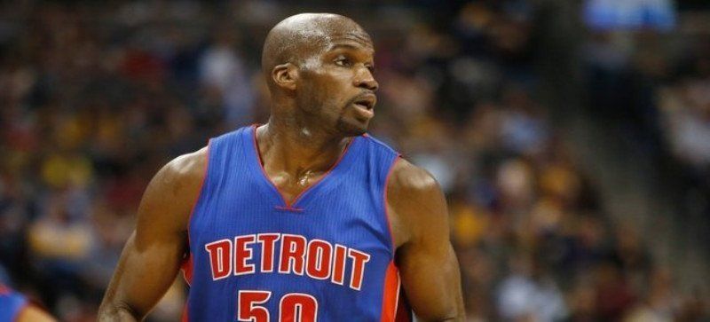 A bald basketball player wearing a detroit 50 jersey