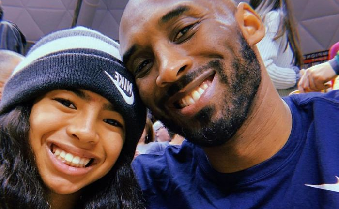 A man and a girl are posing for a picture together and smiling.