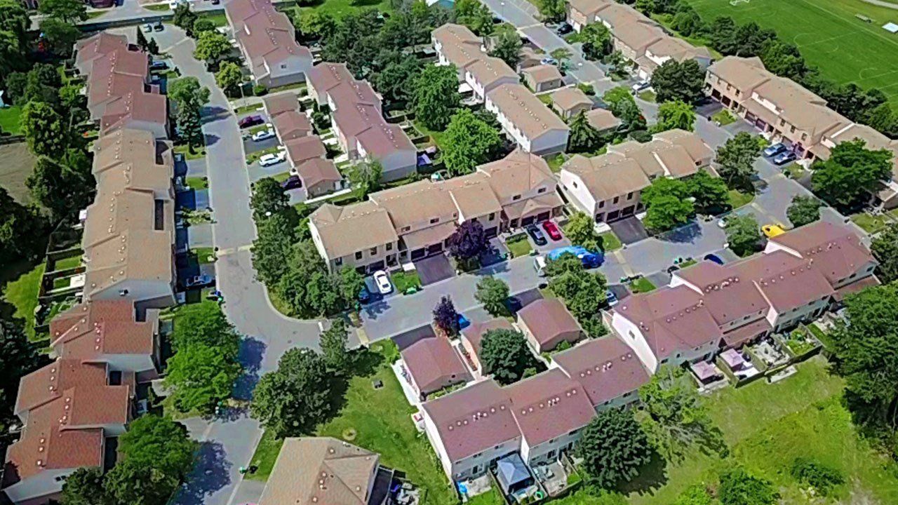 An aerial view of a residential area with lots of houses and trees.