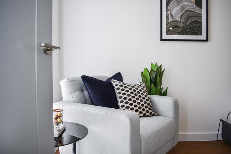 A stylish white sofa with black and white cushions