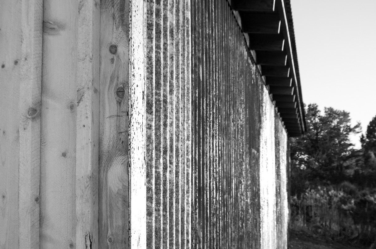 wood siding and corrugated rusted metal