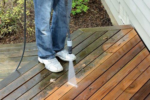 Flooding Foundations — Man Pressure Washing the Deck in Manchester, CT Flooding Foundations — Man Pressure Washing the Deck in Manchester, CT