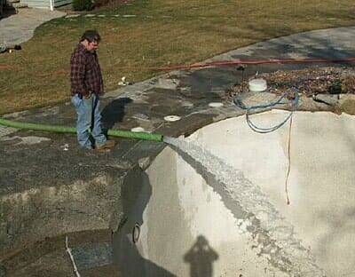 Man Feeling Pool With Water — Construction Sites in Manchester, CT