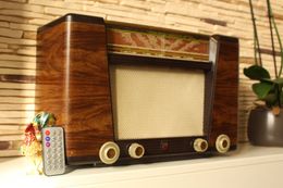 A philips radio is sitting on a shelf next to a remote control