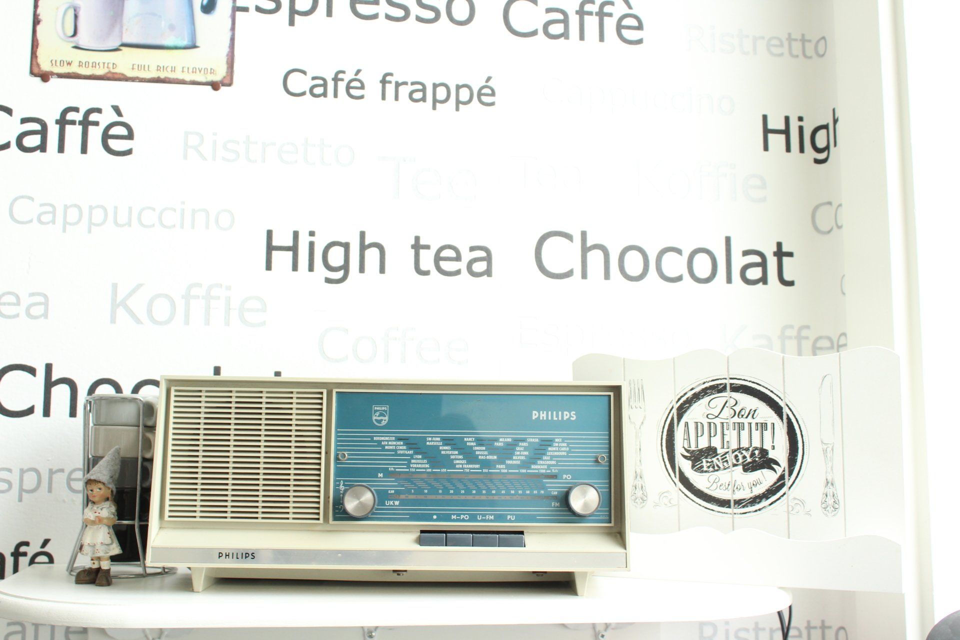A radio is sitting in front of a sign that says high tea chocolat