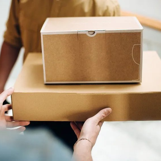 handing over a square and rectangular parcel