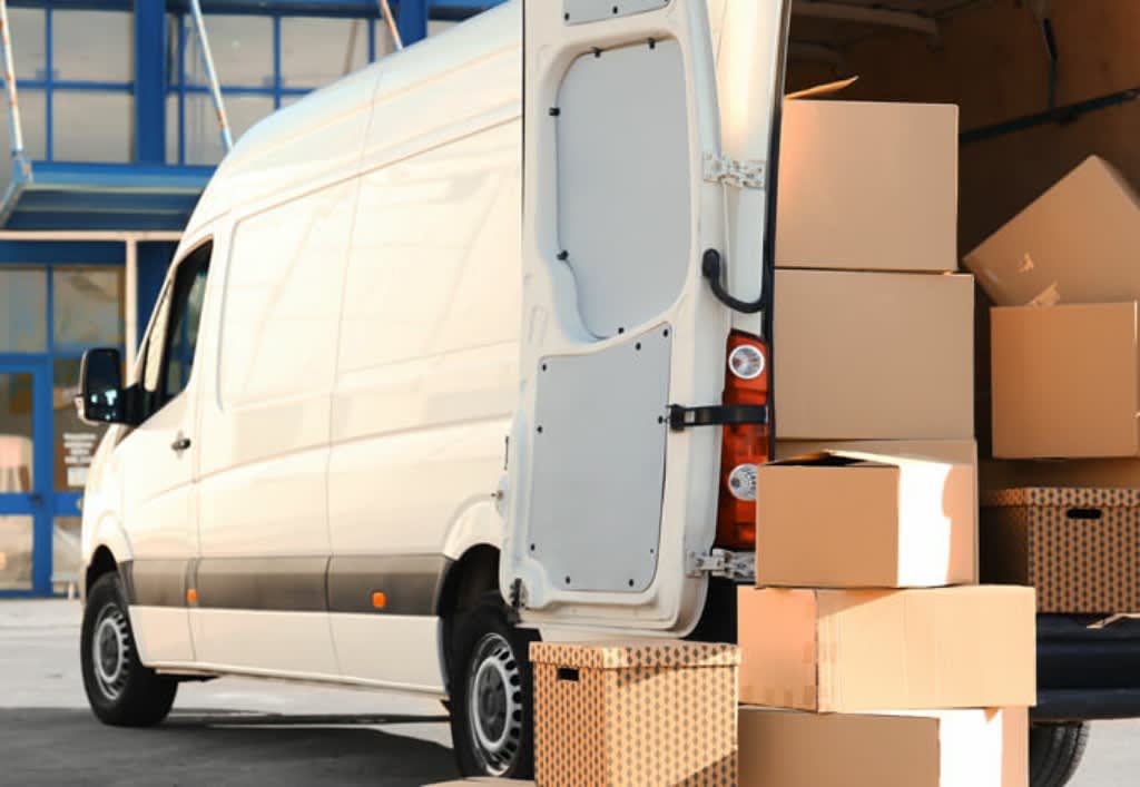 white transit van with cardboard boxes