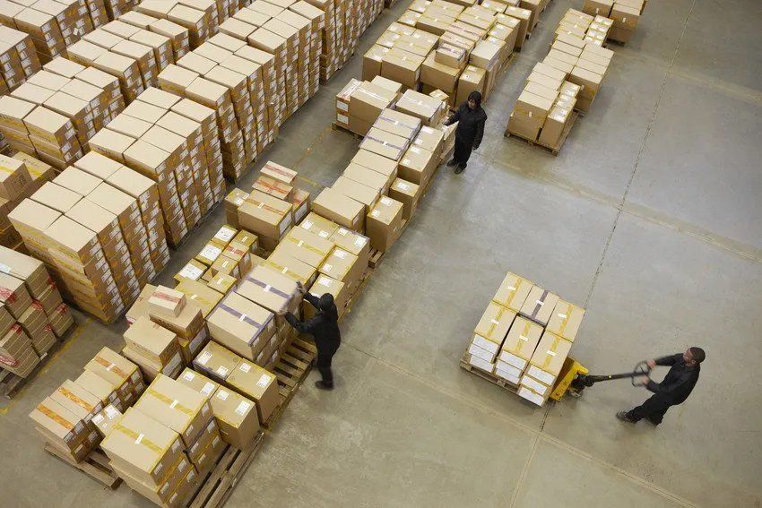 cardboard boxes stacked outside a white van
