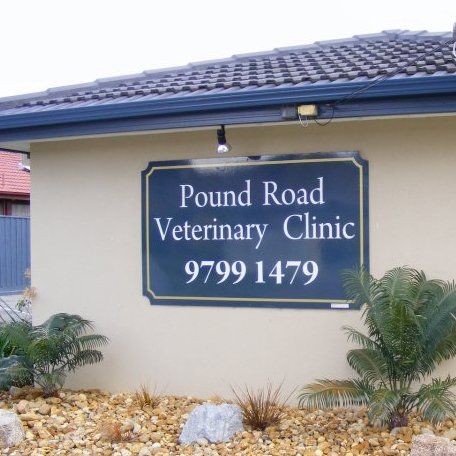 Pound road veterinary clinic sign on the side of a building