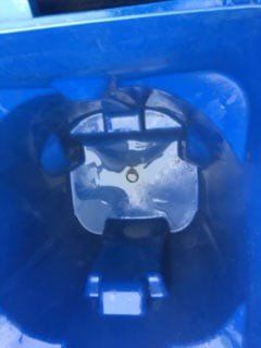 Blue plastic container interior with a central clear, rectangular, lid-support mechanism.