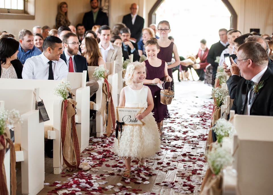 Beautiful flower girls walking down the aisle