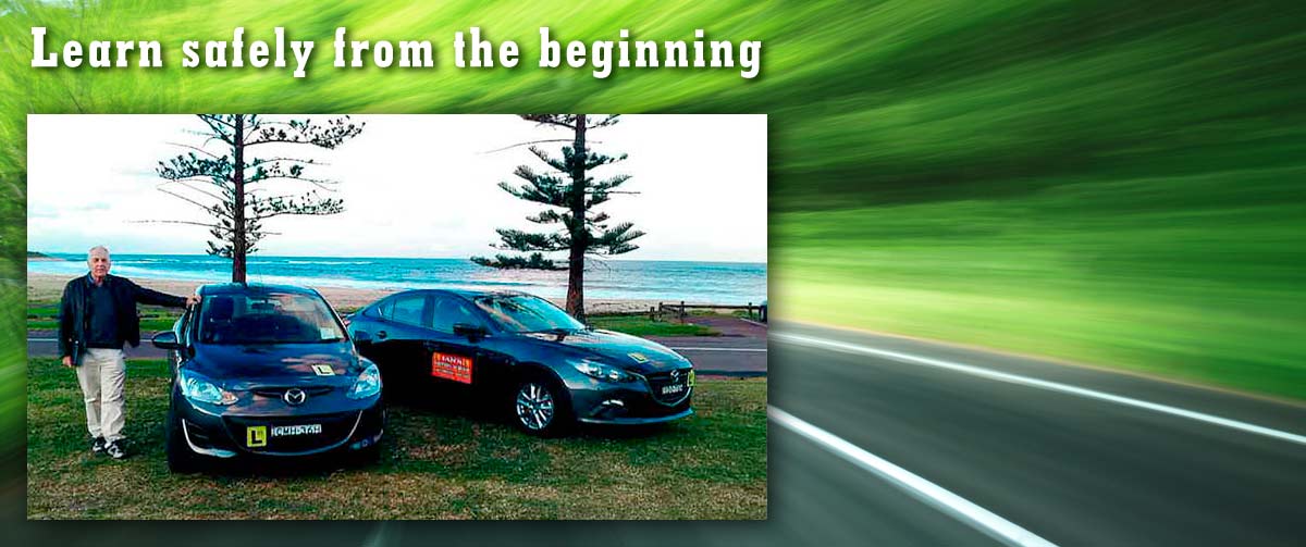 ian with two driving instructor cars