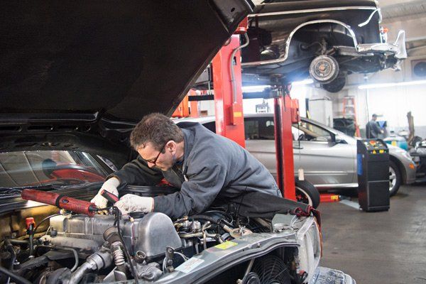 man servicing car
