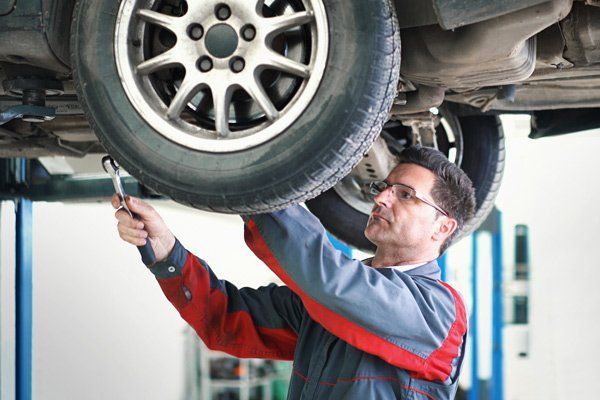man working on car steering