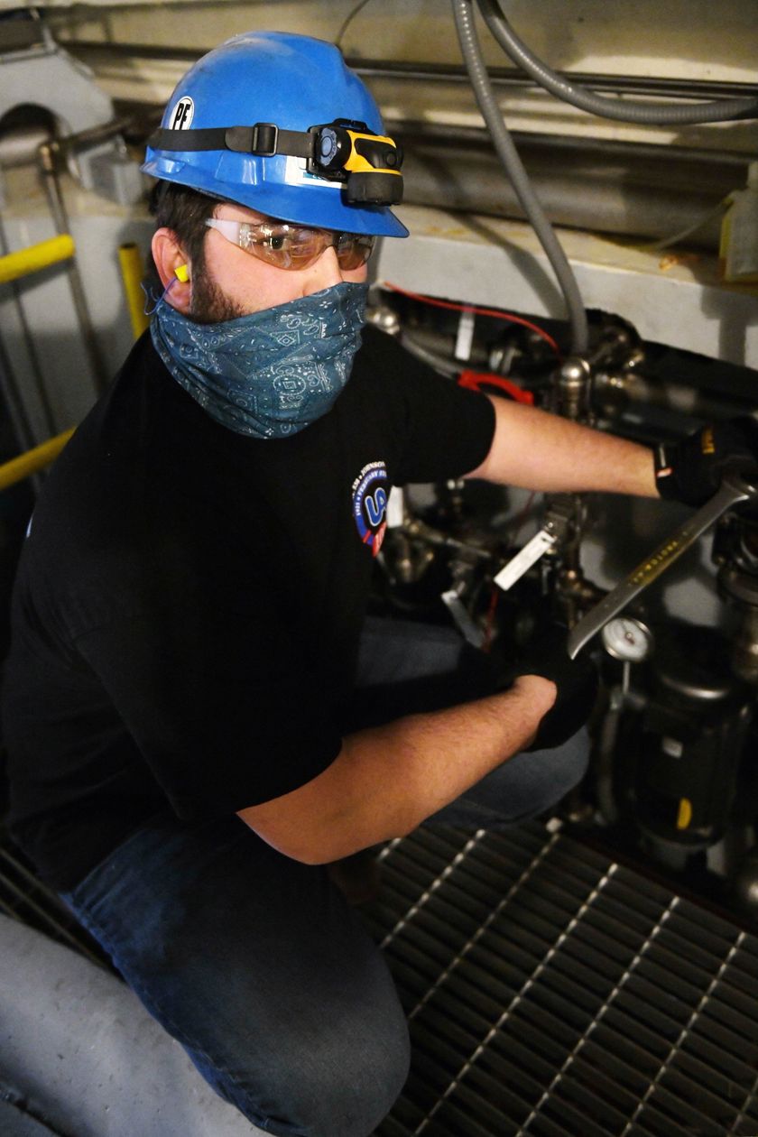 Local 538 Apprentice working on pipes in a lower locatoin