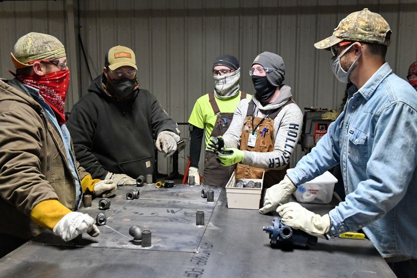 Local 538 Apprentices gathering around to learn from a mentor