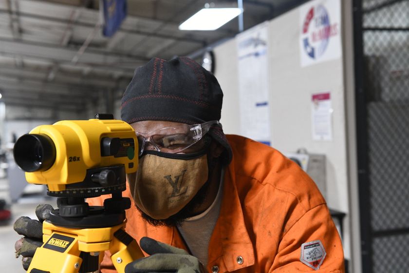 Local 538 Apprentice using a level