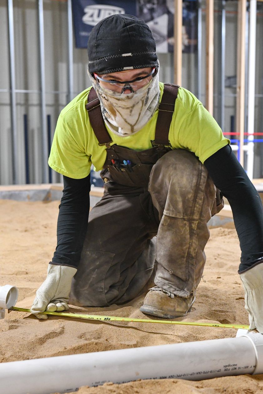 Local 538 Apprentice laying pvc piping to go underground