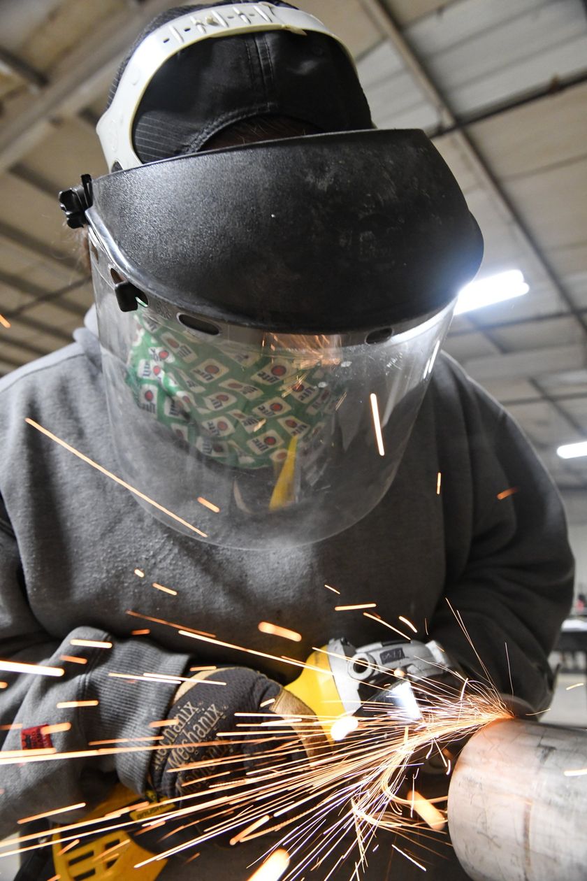 Local 538 Apprentice grinding a pipe to be fitted