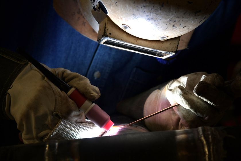 Local 538 Apprentice tig welding in his welding mask