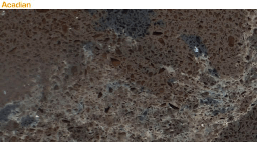 A slab of brown quartz countertop featuring speckled, multi-tonal brown and dark grey flecks and subtle, light veining.