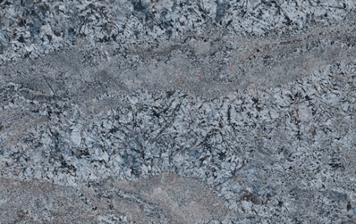 A close-up view of polished granite slab featuring swirling patterns of white, gray, black, and hints of light blue.