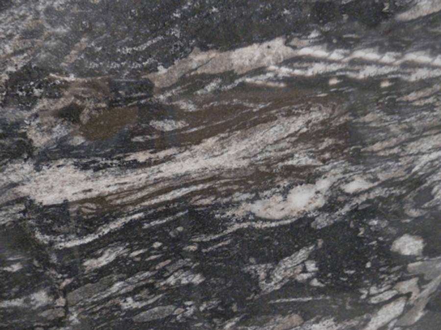A close-up of dark grey granite stone with wavy streaks of black, white, and brown minerals.